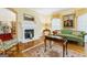Bright living room featuring hardwood floors, a cozy fireplace, and classic decor for a welcoming atmosphere at 256 Allie Dr, Mcdonough, GA 30252