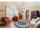 Bright living room with hardwood floors, large arched window, and elegant decor at 256 Allie Dr, Mcdonough, GA 30252