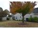 Residential home backyard with tree and landscaped area featuring wood fencing at 410 Mockingbird Dr, Loganville, GA 30052