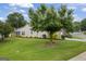 Spacious backyard featuring lush green grass and mature trees, perfect for outdoor enjoyment at 410 Mockingbird Dr, Loganville, GA 30052