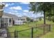 Spacious backyard with lawn, black metal fence and the rear exterior of the house at 410 Mockingbird Dr, Loganville, GA 30052