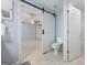 Bathroom showcasing an open sliding barn door, tile flooring and neutral paint at 410 Mockingbird Dr, Loganville, GA 30052