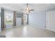 A spacious bedroom with tile flooring, ceiling fan, two windows and neutral walls at 410 Mockingbird Dr, Loganville, GA 30052