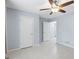 Bedroom with neutral paint, tile flooring, ceiling fan, and white doors for closet and hallway at 410 Mockingbird Dr, Loganville, GA 30052