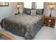 This bedroom is furnished with a queen bed, two side tables, and wood floors at 410 Mockingbird Dr, Loganville, GA 30052