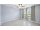 Bedroom featuring a window with curtains, neutral paint, tile flooring, and multiple electric outlets at 410 Mockingbird Dr, Loganville, GA 30052