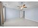 Light-filled bedroom showcases tile flooring, neutral walls, and a ceiling fan at 410 Mockingbird Dr, Loganville, GA 30052