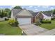 Charming one-story brick home featuring a two-car garage and well-maintained landscaping at 410 Mockingbird Dr, Loganville, GA 30052