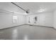 Epoxy floor garage with extra storage space and two white doors to exterior at 410 Mockingbird Dr, Loganville, GA 30052