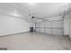 Spacious two-car garage with epoxy flooring, automatic door opener, and ample space at 410 Mockingbird Dr, Loganville, GA 30052