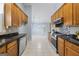Charming kitchen features wood cabinets, granite countertops, stainless steel appliances, and tile backsplash at 410 Mockingbird Dr, Loganville, GA 30052