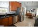 This kitchen features stainless steel appliances, tile floors, and wood cabinets at 410 Mockingbird Dr, Loganville, GA 30052