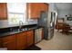 Kitchen with stainless steel appliances and wooden cabinets at 410 Mockingbird Dr, Loganville, GA 30052