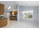 Eat-in kitchen features wood cabinets, black countertops, tile floors, and stainless steel appliances at 410 Mockingbird Dr, Loganville, GA 30052