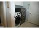 Modern laundry room features a washer and dryer set with cabinet storage and tile flooring at 410 Mockingbird Dr, Loganville, GA 30052