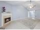 Cozy living room showcases a fireplace, tile flooring, and a ceiling fan for added comfort at 410 Mockingbird Dr, Loganville, GA 30052