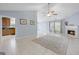 Bright living room featuring tile floors, fireplace, and seamless transition to the kitchen and dining area at 410 Mockingbird Dr, Loganville, GA 30052