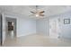 Spacious main bedroom features a ceiling fan, tile floors, and ensuite bathroom and walk-in closet access at 410 Mockingbird Dr, Loganville, GA 30052