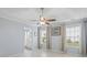 Bright main bedroom with a ceiling fan, tile floors, two windows and ensuite bathroom access at 410 Mockingbird Dr, Loganville, GA 30052
