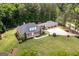 An expansive single-story brick home features mature trees, a three-car garage, and a well-manicured lawn at 401 Robinson Rd, Peachtree City, GA 30269