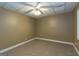 Finished basement with neutral walls, carpet, ceiling fan, and a bright window at 401 Robinson Rd, Peachtree City, GA 30269