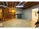 Unfinished basement showcasing exposed framework, ductwork, and utility connections, offering a blank canvas for development at 401 Robinson Rd, Peachtree City, GA 30269