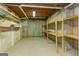 Basement area showing the unfinished storage space with wooden shelving and concrete walls at 401 Robinson Rd, Peachtree City, GA 30269