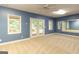 Finished basement with blue walls, carpet, a ceiling fan, a set of glass doors, and a large mirror at 401 Robinson Rd, Peachtree City, GA 30269
