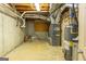 Mechanical room in basement features a newer furnace, water heater and exposed ductwork at 401 Robinson Rd, Peachtree City, GA 30269