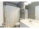 A bathroom with a white shower curtain, toilet, vanity, mirror and gray painted walls at 401 Robinson Rd, Peachtree City, GA 30269