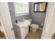 A cozy bathroom showcasing a vanity sink, toilet, neutral colors, and a framed mirror at 401 Robinson Rd, Peachtree City, GA 30269
