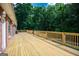 Expansive wooden deck provides ample space for outdoor dining and relaxation with lush green tree views at 401 Robinson Rd, Peachtree City, GA 30269