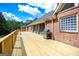 Large wooden deck features ample space for outdoor entertaining, complemented by a stainless steel grill at 401 Robinson Rd, Peachtree City, GA 30269