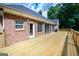 Expansive wooden deck is perfect for entertaining, and leads to a beautiful home interior via glass doors at 401 Robinson Rd, Peachtree City, GA 30269