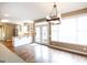 Dining area with hardwood floors, modern lighting, and direct access to the kitchen and outdoor patio at 401 Robinson Rd, Peachtree City, GA 30269