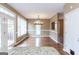 Open dining room with hardwood floors, contemporary lighting, and access to the backyard through glass doors at 401 Robinson Rd, Peachtree City, GA 30269