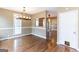 Dining room with wood floors, large window, and modern chandelier, offering a stylish space for gatherings at 401 Robinson Rd, Peachtree City, GA 30269