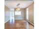 Spacious dining area featuring hardwood floors, contemporary lighting, and a view to the backyard at 401 Robinson Rd, Peachtree City, GA 30269