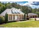 Brick home with a columned front porch, dormer windows, and an attached three-car garage at 401 Robinson Rd, Peachtree City, GA 30269