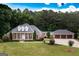 Stately brick home boasts a manicured lawn, attached three-car garage and a welcoming front porch at 401 Robinson Rd, Peachtree City, GA 30269