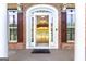 Elegant front entrance with brick facade, arched doorway, and double windows at 401 Robinson Rd, Peachtree City, GA 30269