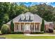 Charming brick home with a columned front porch, dormer windows, and manicured landscaping at 401 Robinson Rd, Peachtree City, GA 30269