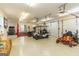 Spacious garage with high ceilings, a golf cart, and a zero turn lawn mower at 401 Robinson Rd, Peachtree City, GA 30269