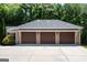 Attached three-car garage with brick exterior and ample driveway space surrounded by mature trees at 401 Robinson Rd, Peachtree City, GA 30269