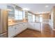 Well-lit kitchen featuring granite countertops, stainless steel appliances, and white cabinets at 401 Robinson Rd, Peachtree City, GA 30269