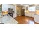 Well-lit kitchen featuring granite countertops, stainless steel appliances, and tiled backsplash at 401 Robinson Rd, Peachtree City, GA 30269