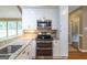 White kitchen cabinets, stainless steel appliances, and granite counters at 401 Robinson Rd, Peachtree City, GA 30269