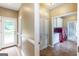 A modern laundry room with custom cabinetry, red washer/dryer units, and outdoor access at 401 Robinson Rd, Peachtree City, GA 30269