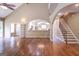 Open floor plan with hardwood floors, living room, kitchen, and staircase at 401 Robinson Rd, Peachtree City, GA 30269