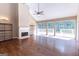 Large living room with fireplace, hardwood floors, and access to a balcony at 401 Robinson Rd, Peachtree City, GA 30269